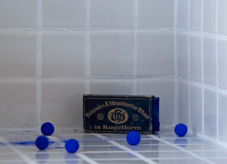 Save the Day – The Day Yves Klein Lost His Marbels in a Laundry (Detail), 2013 Wooden Box, Tiles, Blue Wasching Balls, Glass, Text, 28 x 31 x 31 cm