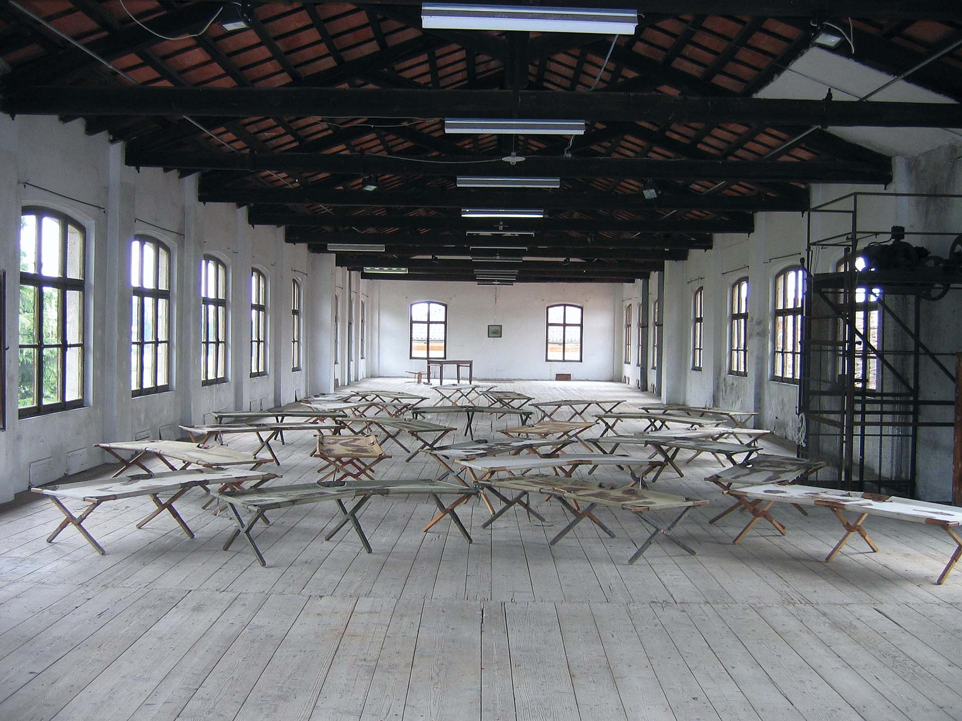 Lager, Third Version, 1992 Body Prints and Stancel Writing on Cots – 24 pieces View into the Exhibition Hicetnunc 2004, San Vito al Tagliamento, 2004