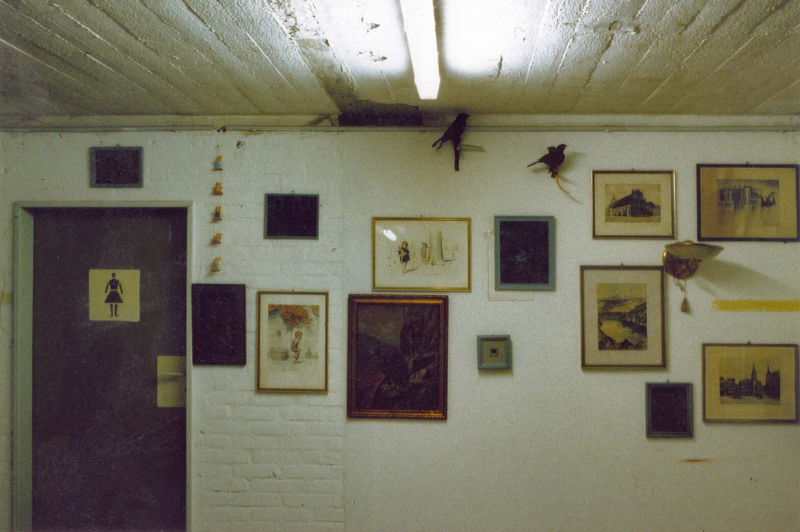 1000 Jahre Frohsinn (1000 Years of Cheerfulness) as part of the installation BombenBunkerStimmung next to the entrance. This part of the Air Raid Shelter was used by an Antiquities Dealer. The images with the grey frames and the Silver Gelatine Prints on Glass in Front of a a Grey Background were added by me; View into the exhibition Zeit, organised by GaDeWe in one of Bemen's Air Raid Shelters from the Second World War, Bremen, 2000